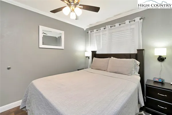 a large bed sitting in a bedroom next to a window