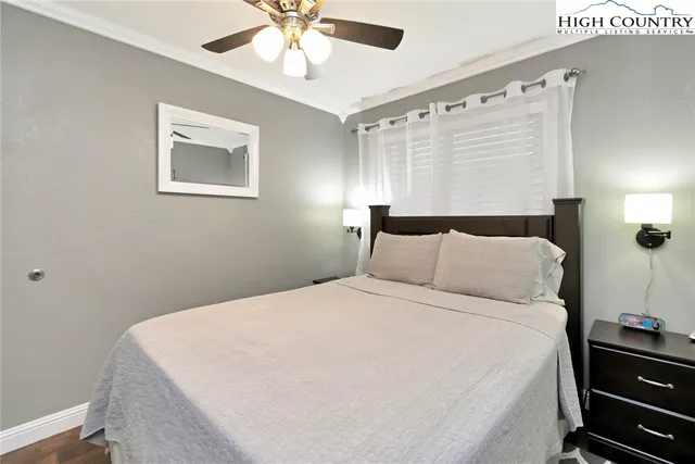 a large bed sitting in a bedroom next to a window