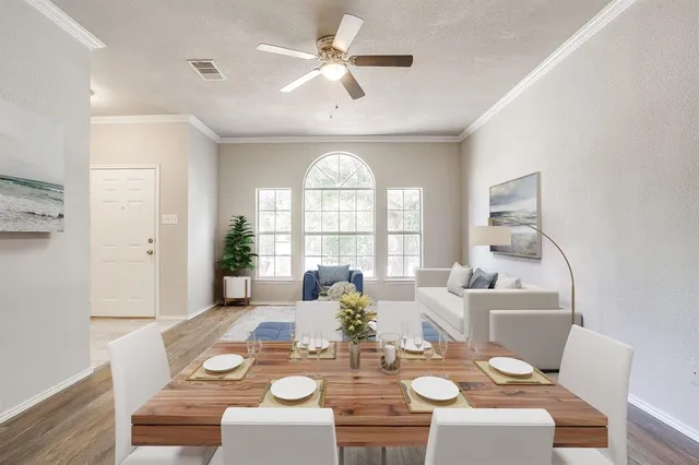 a view of a dining room with furniture a chandelier and wooden floor