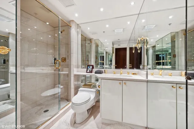 a bathroom with a toilet a sink and a shower