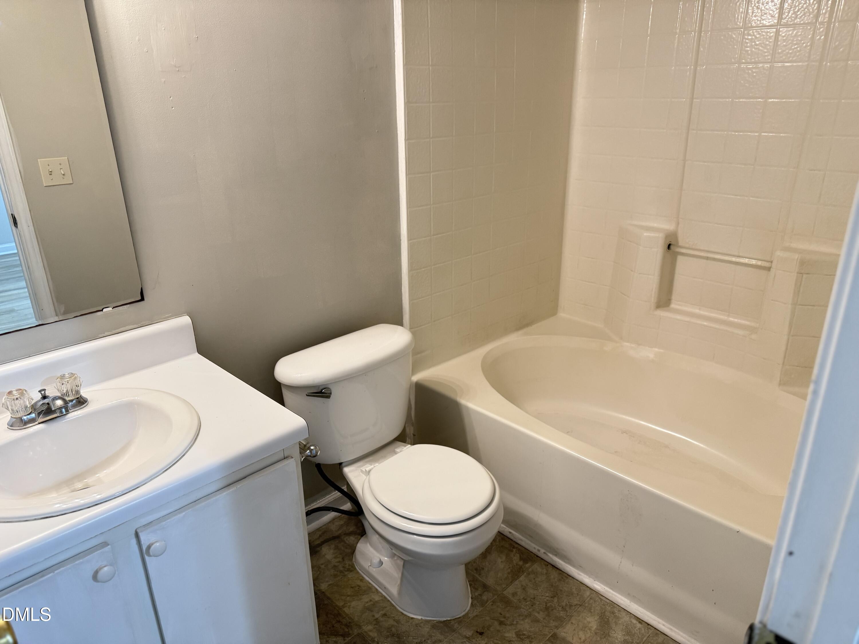 4832 Silverdene Street Raleigh, NC 27616 - Photo 11 of 15 a white toilet sitting next to a bath tub