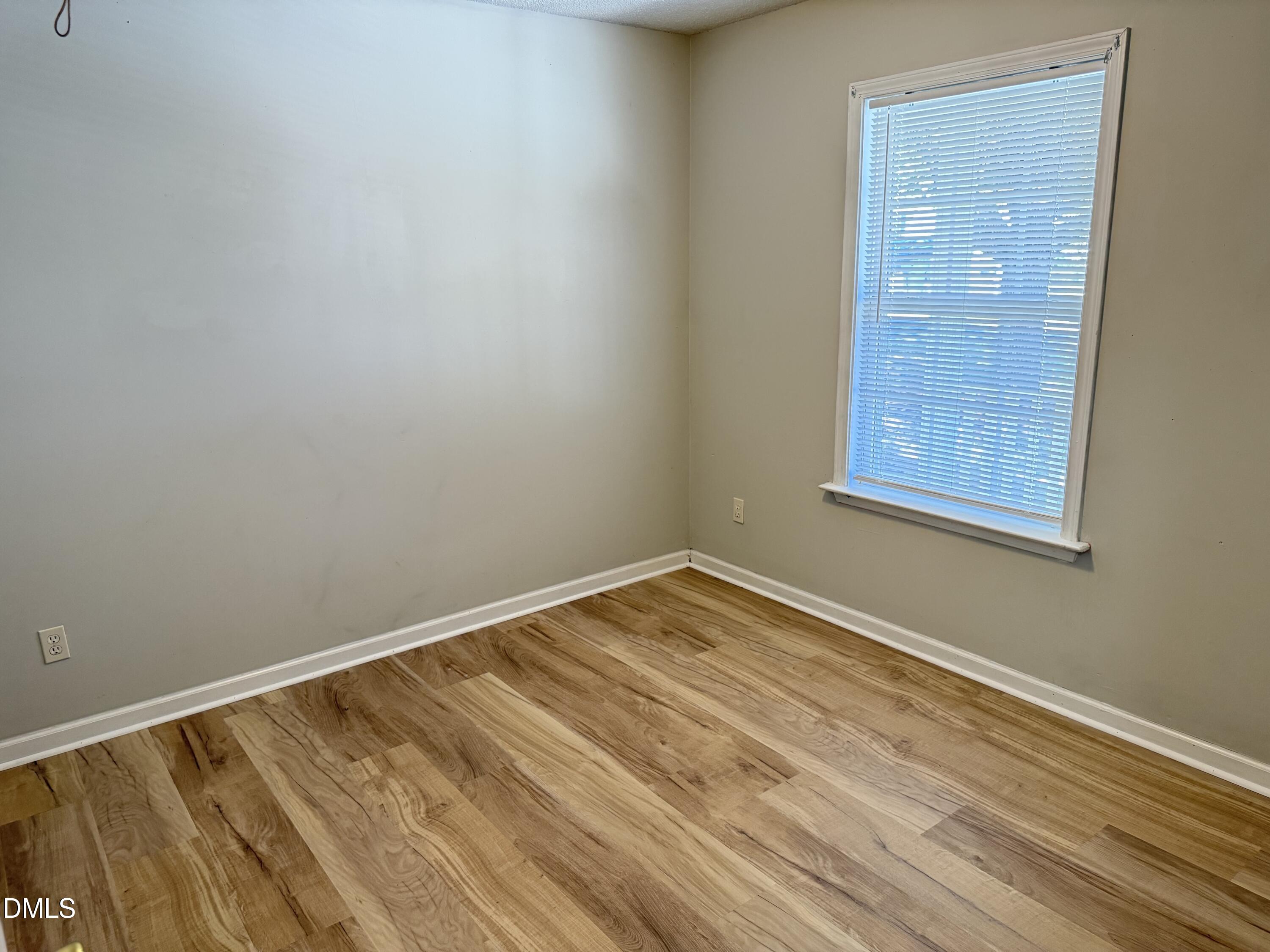 4832 Silverdene Street Raleigh, NC 27616 - Photo 14 of 15 a view of empty room with wooden floor and fan