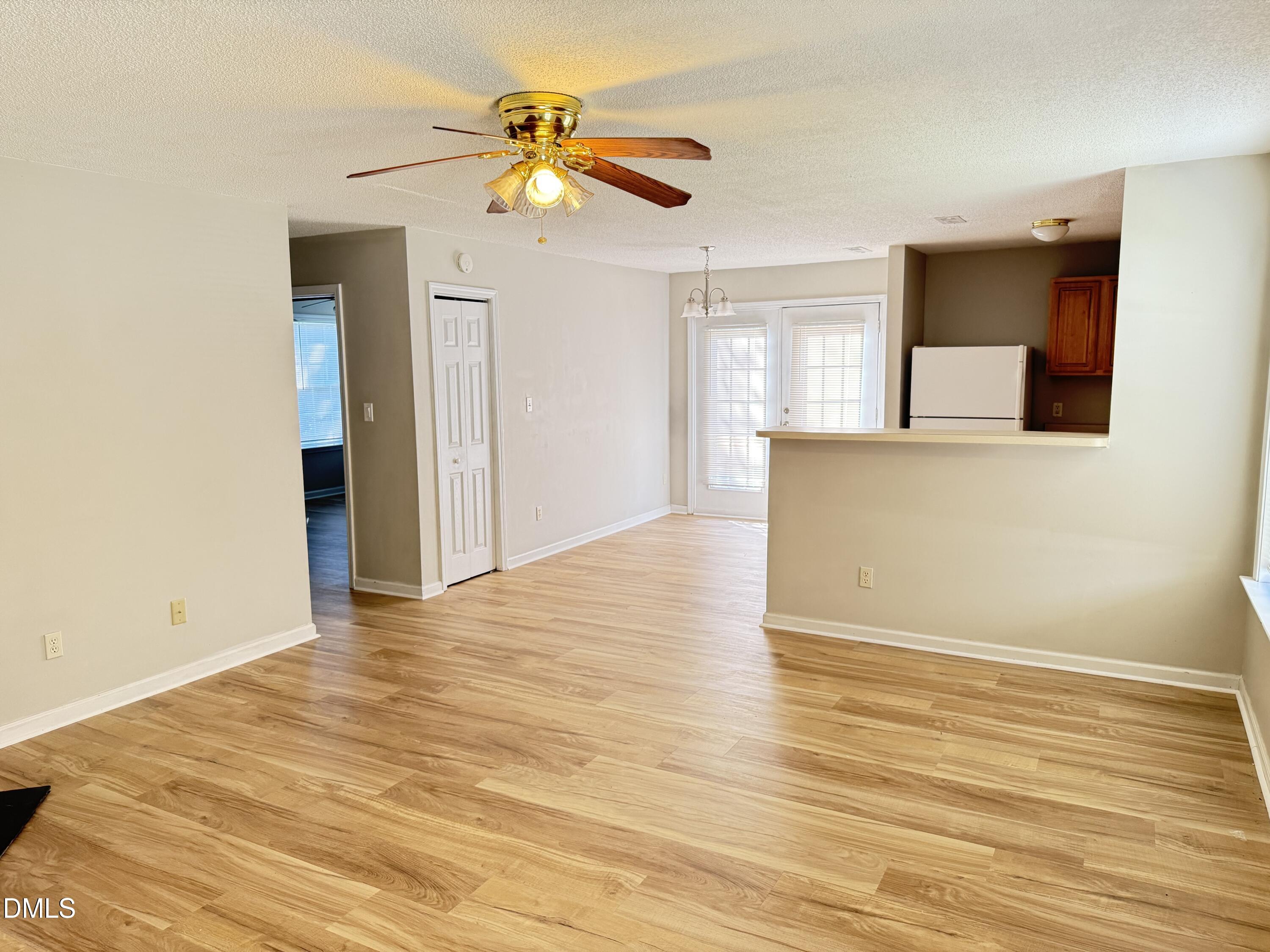 4832 Silverdene Street Raleigh, NC 27616 - Photo 4 of 15 an empty room with wooden floor and windows