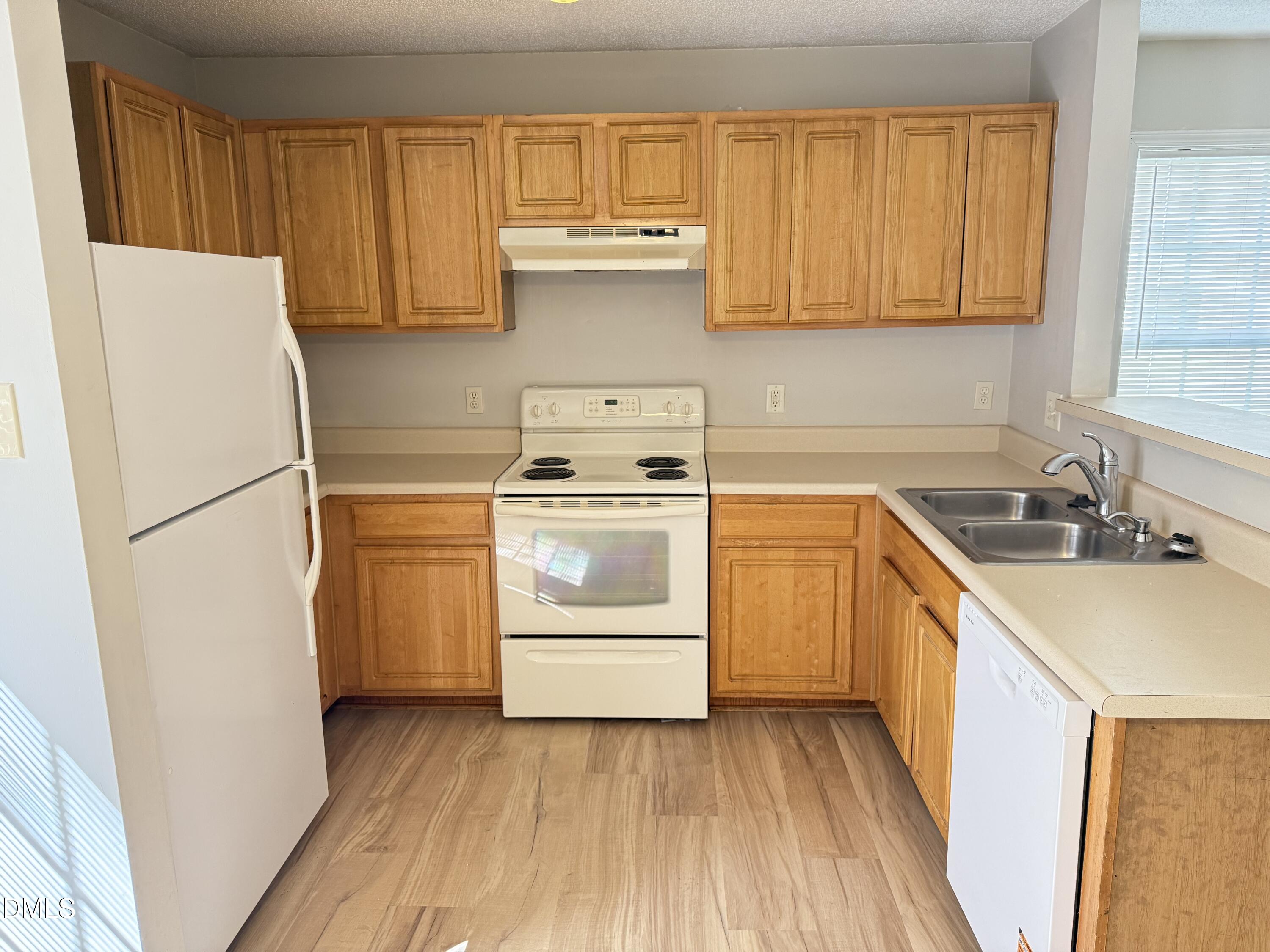4832 Silverdene Street Raleigh, NC 27616 - Photo 7 of 15 a kitchen with a sink a stove and refrigerator