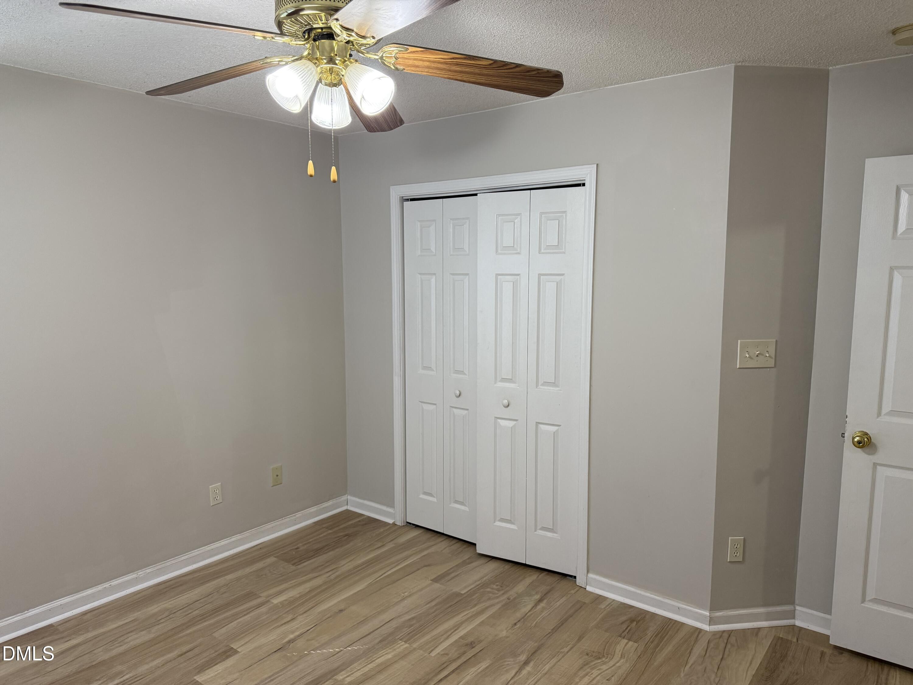 4832 Silverdene Street Raleigh, NC 27616 - Photo 10 of 15 an empty room with wooden floor fan and window