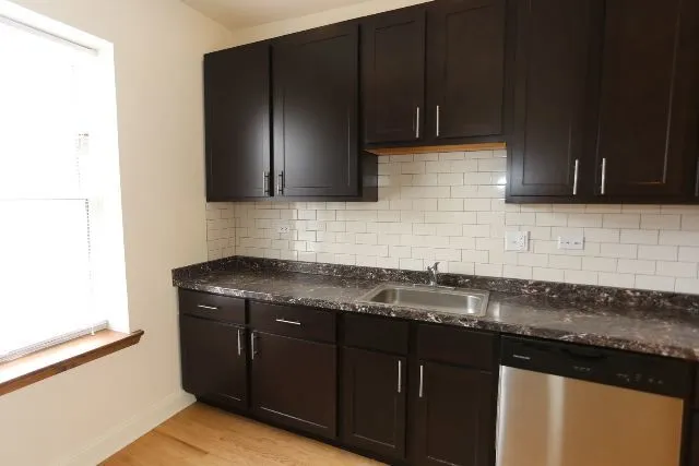 a kitchen with granite countertop stainless steel appliances and cabinets