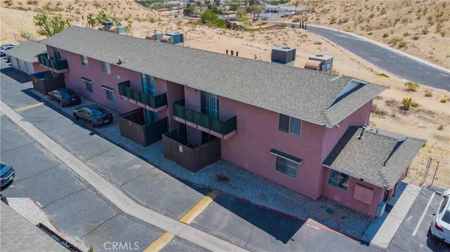 a aerial view of a house with a large tree