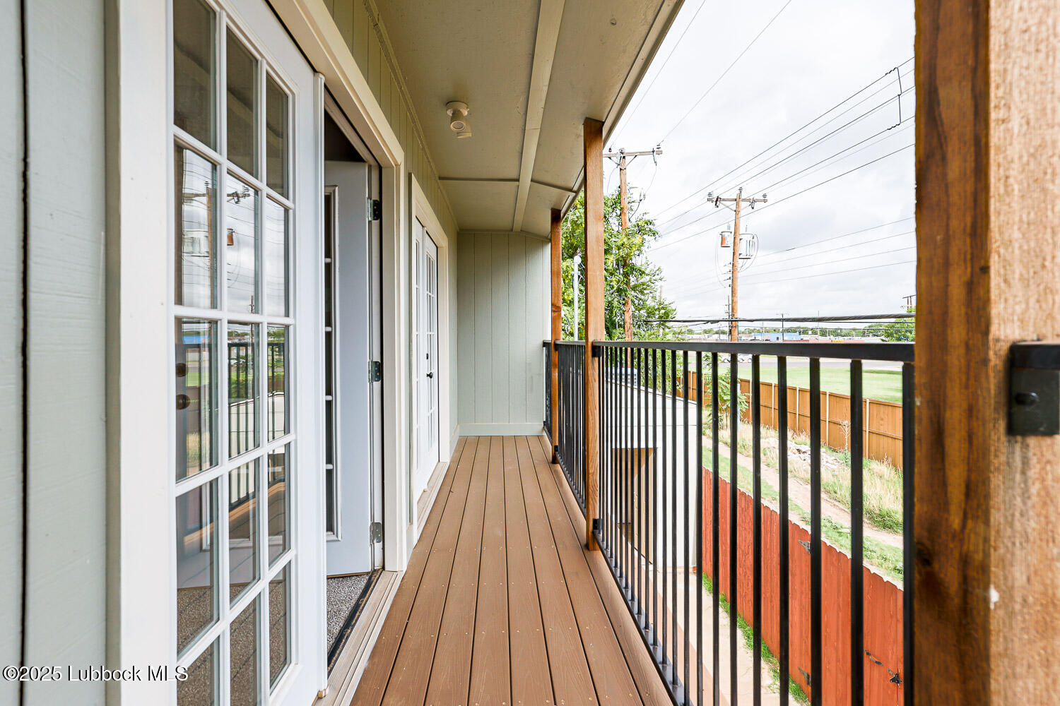 4314 52nd Street, Unit A Lubbock, TX 79413 - Photo 13 of 54 a view of a balcony with wooden floor and fence