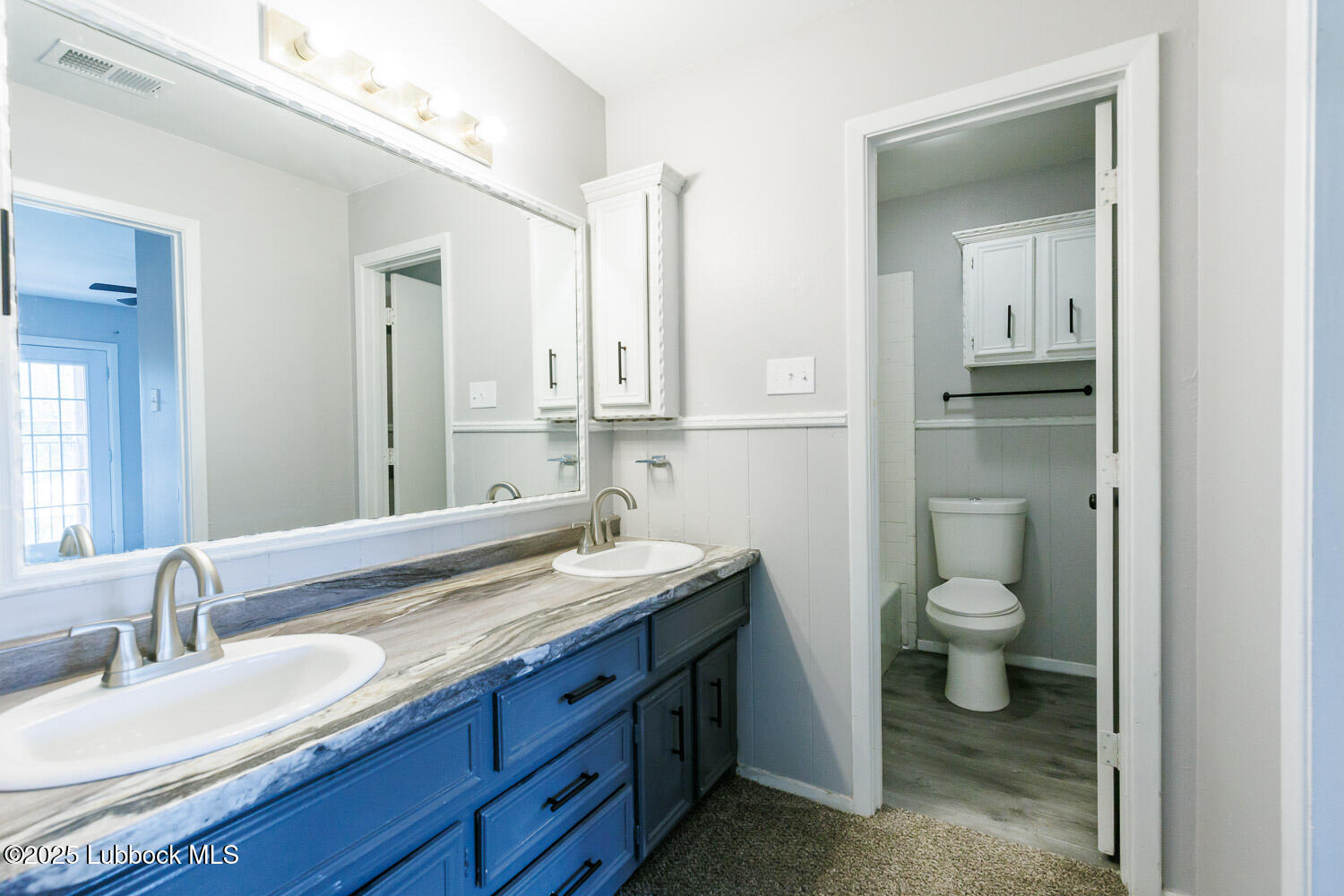 4314 52nd Street, Unit A Lubbock, TX 79413 - Photo 19 of 54 a bathroom with a granite countertop sink toilet and mirror