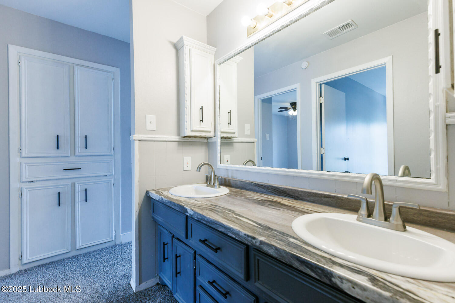 4314 52nd Street, Unit A Lubbock, TX 79413 - Photo 21 of 54 a bathroom with a granite countertop double sink and a mirror
