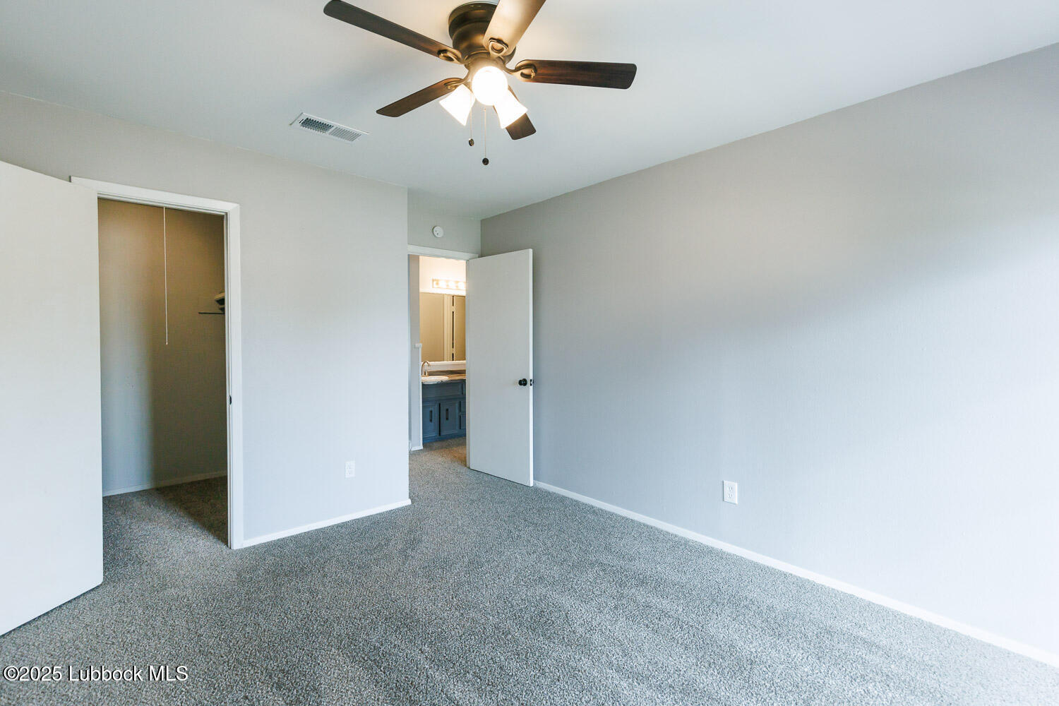 4314 52nd Street, Unit A Lubbock, TX 79413 - Photo 23 of 54 an empty room with closet and a chandelier fan