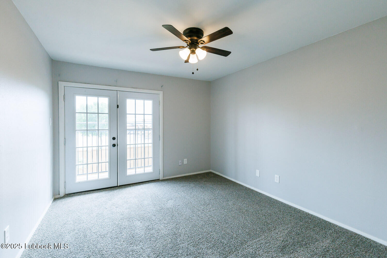 4314 52nd Street, Unit A Lubbock, TX 79413 - Photo 25 of 54 an empty room with windows and ceiling fan