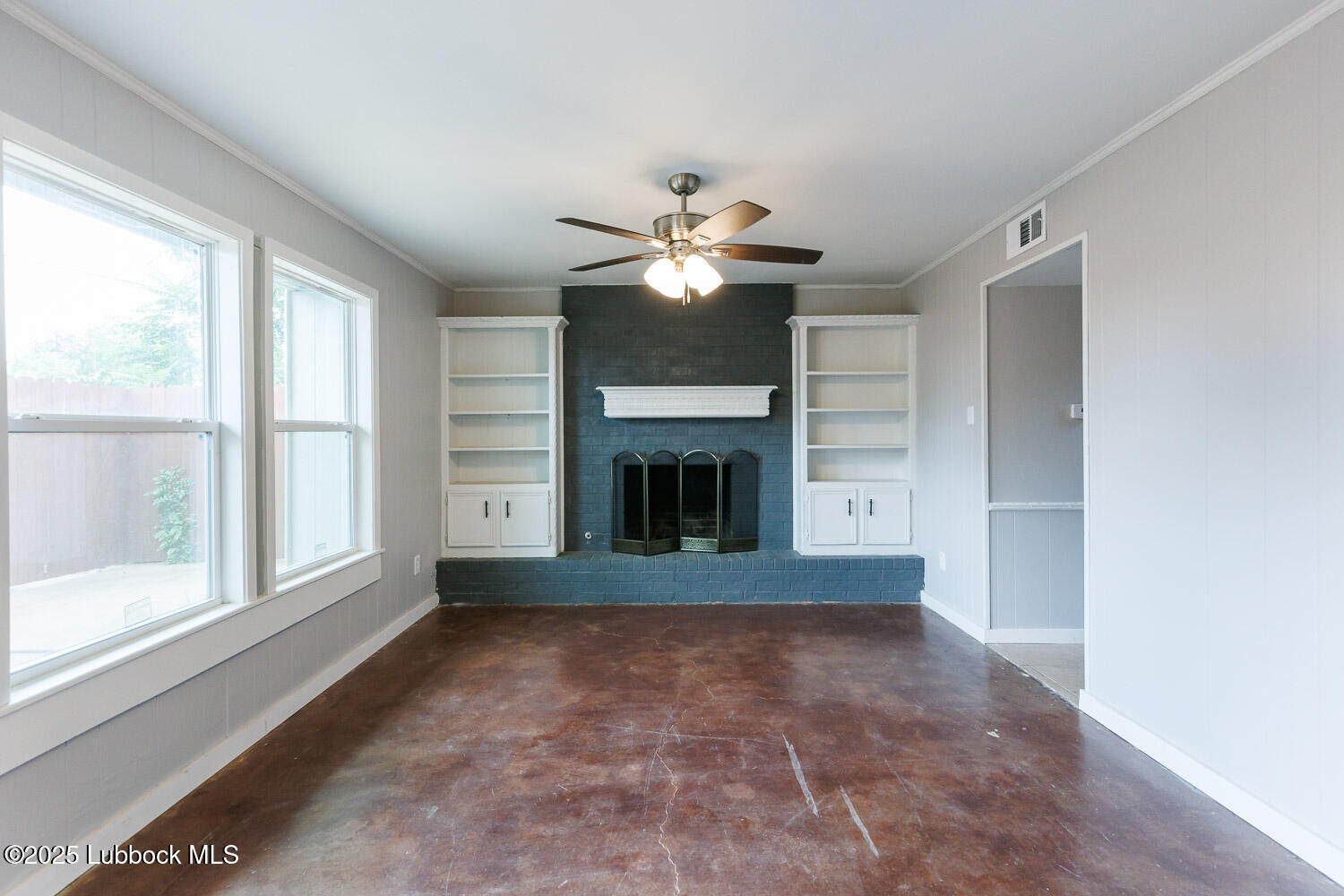 4314 52nd Street, Unit A Lubbock, TX 79413 - Photo 31 of 54 a view of a livingroom with a ceiling fan and window