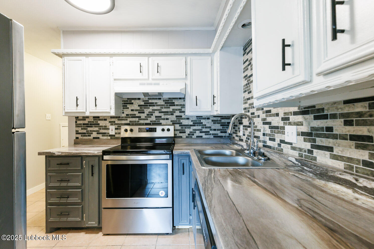 4314 52nd Street, Unit A Lubbock, TX 79413 - Photo 35 of 54 a kitchen with granite countertop a stove sink and cabinets