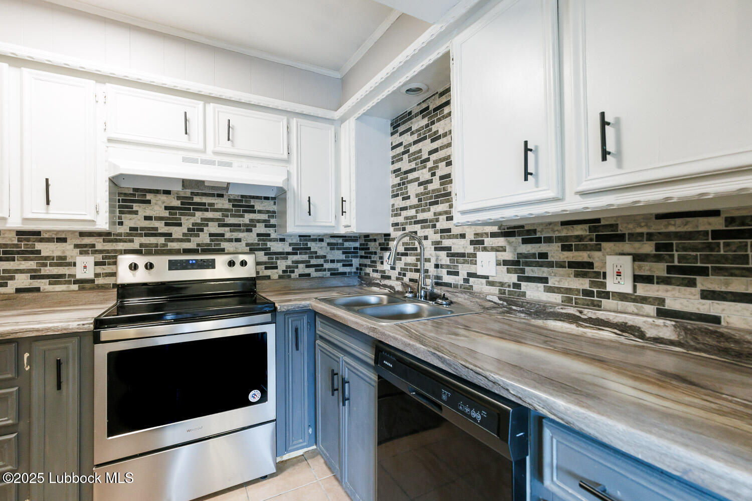 4314 52nd Street, Unit A Lubbock, TX 79413 - Photo 36 of 54 a kitchen with granite countertop a stove sink and cabinets