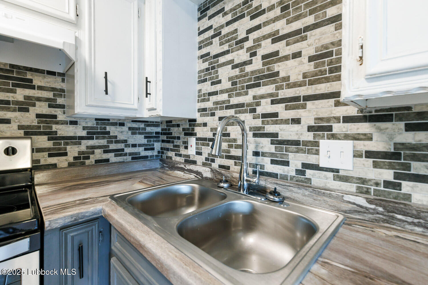4314 52nd Street, Unit A Lubbock, TX 79413 - Photo 37 of 54 a kitchen with a sink and a stove top oven