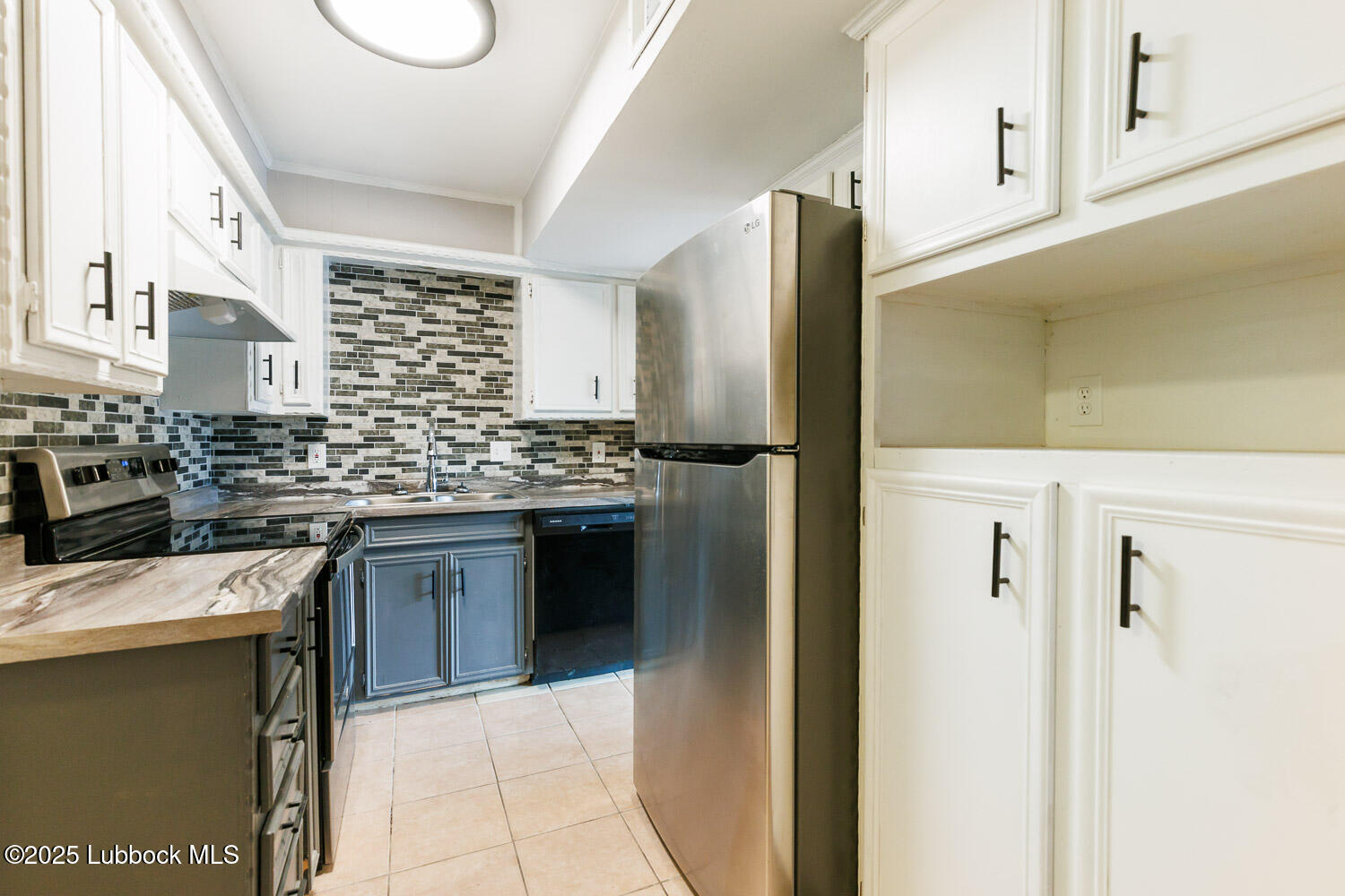 4314 52nd Street, Unit A Lubbock, TX 79413 - Photo 39 of 54 a kitchen with stainless steel appliances a refrigerator sink and stove