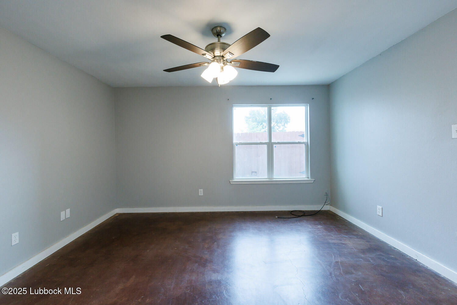 4314 52nd Street, Unit A Lubbock, TX 79413 - Photo 48 of 54 an empty room with wooden floor fan and windows