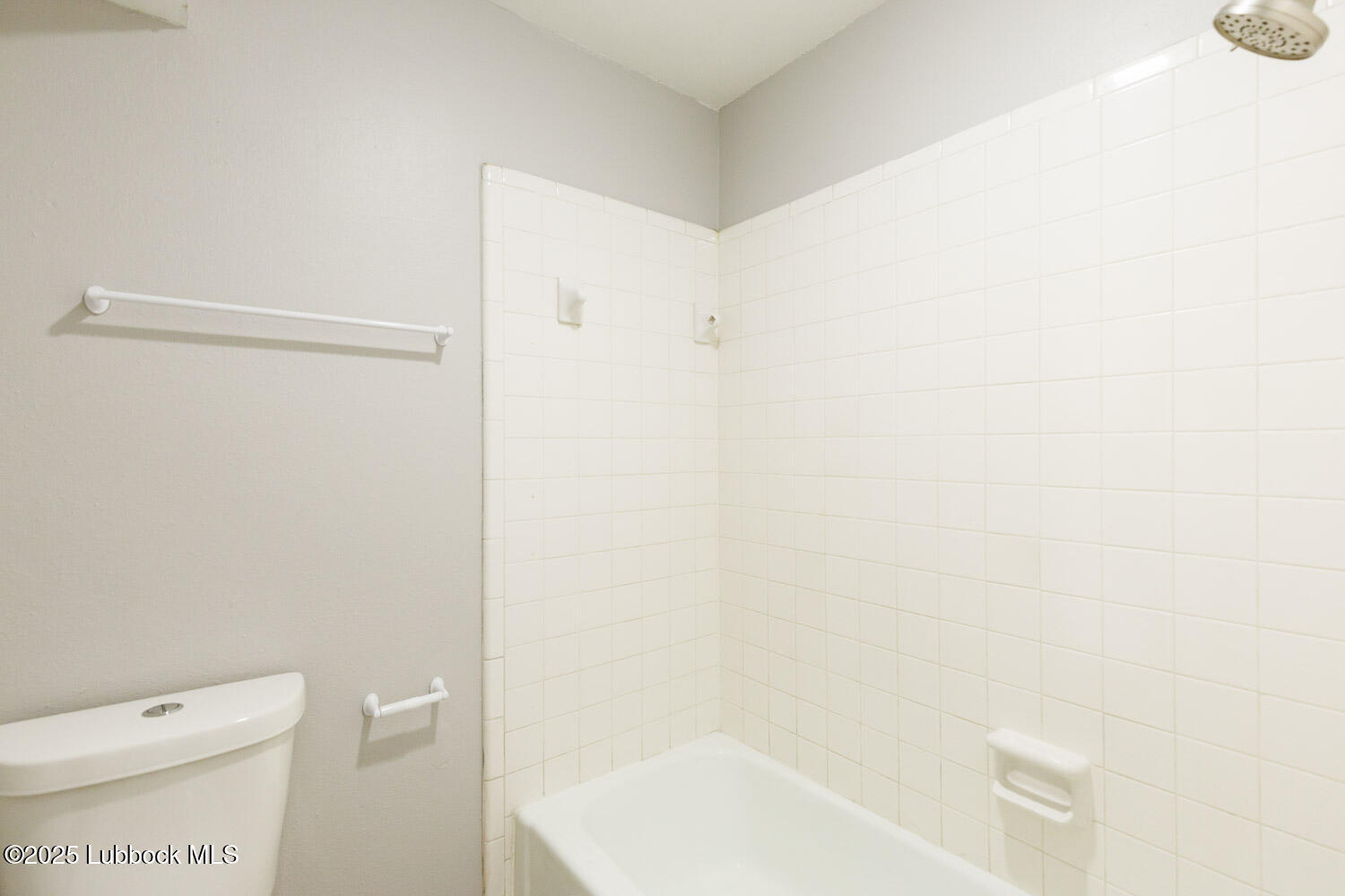 4314 52nd Street, Unit A Lubbock, TX 79413 - Photo 51 of 54 a white toilet sitting next to a bath tub