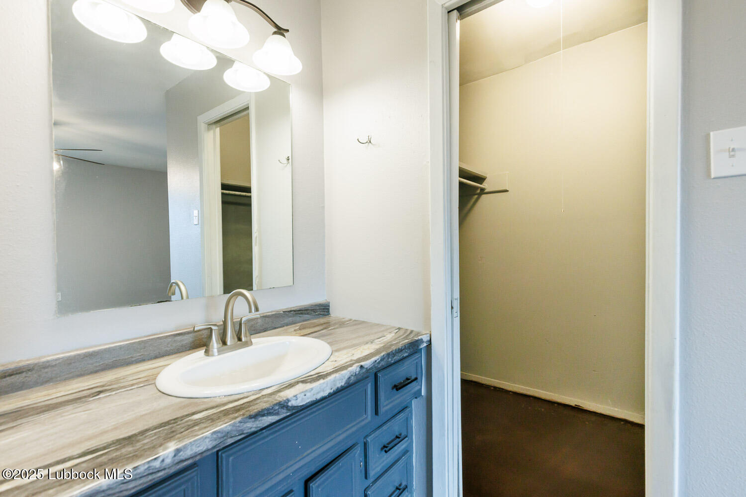 4314 52nd Street, Unit A Lubbock, TX 79413 - Photo 53 of 54 a bathroom with a sink and a mirror