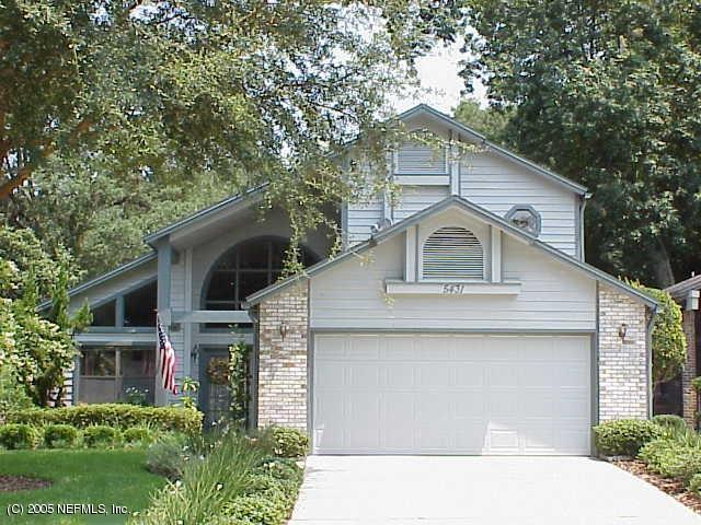 5431 Spring Brook Road Jacksonville, FL 32277 - Photo 1 of 1 a front view of a house with garage and trees