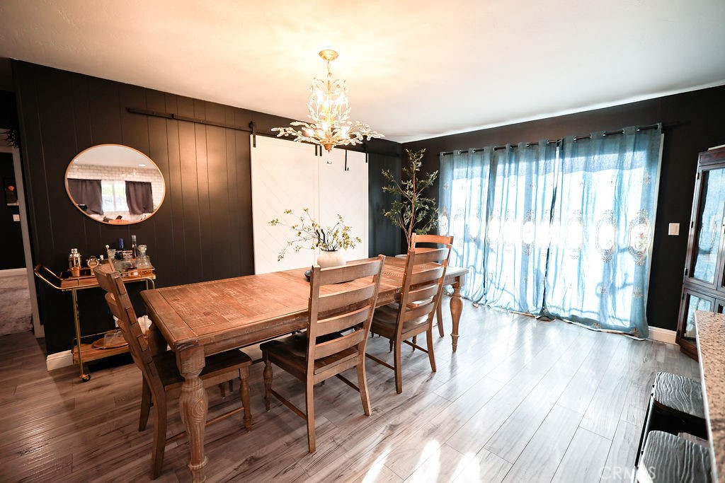 1156 3rd Street Calimesa, CA 92320 - Photo 11 of 34 a view of a dining room with furniture window and wooden floor