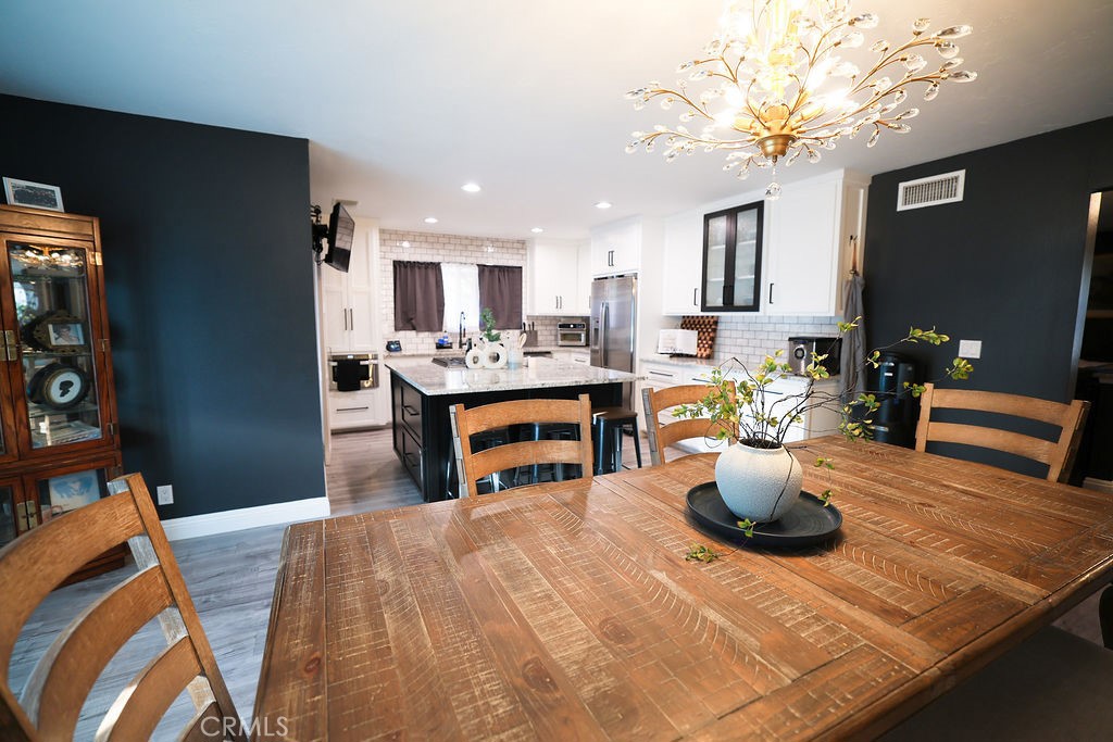 1156 3rd Street Calimesa, CA 92320 - Photo 12 of 34 a living room with stainless steel appliances furniture a rug and a kitchen view