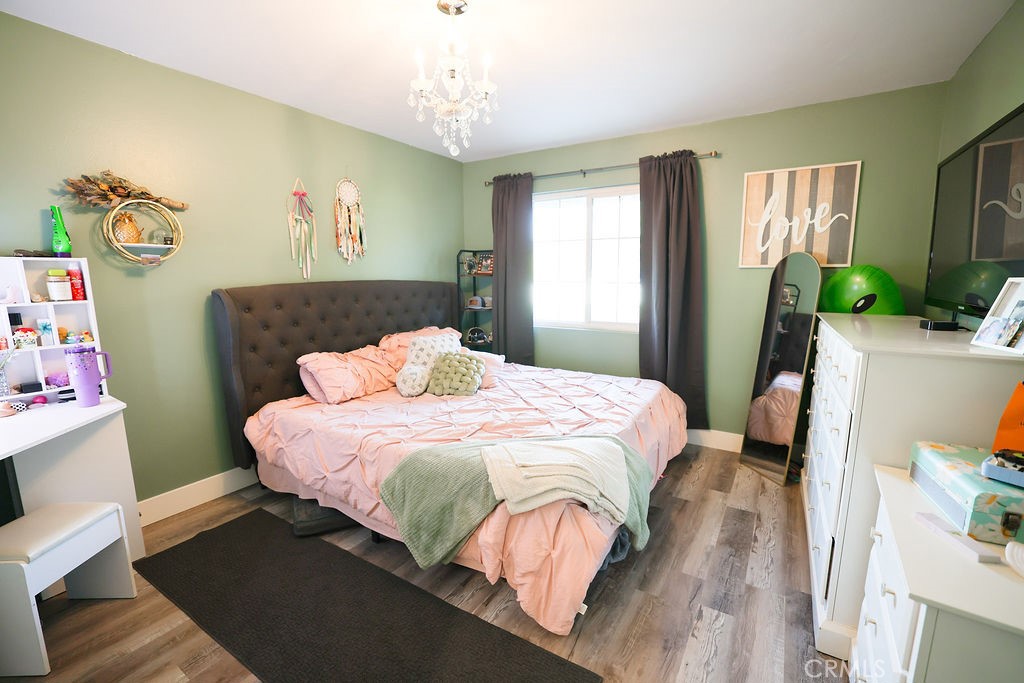 1156 3rd Street Calimesa, CA 92320 - Photo 17 of 34 a bedroom with a bed dresser and window