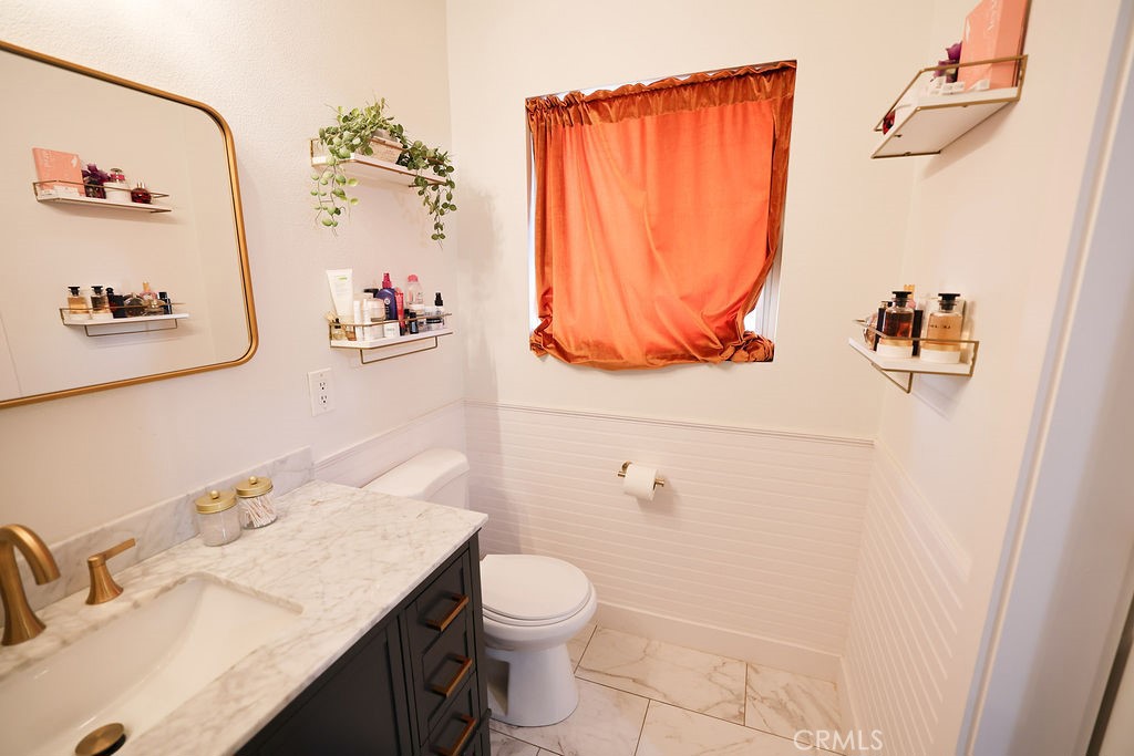 1156 3rd Street Calimesa, CA 92320 - Photo 21 of 34 a bathroom with a sink vanity mirror and toilet