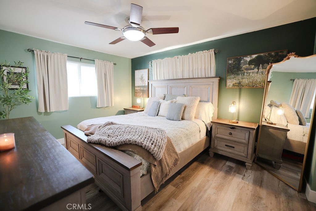 1156 3rd Street Calimesa, CA 92320 - Photo 24 of 34 a bedroom with a bed and a chandelier