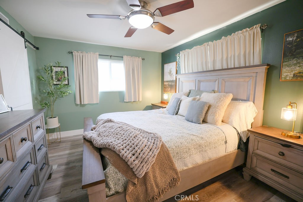 1156 3rd Street Calimesa, CA 92320 - Photo 25 of 34 a bedroom with a bed and a chandelier