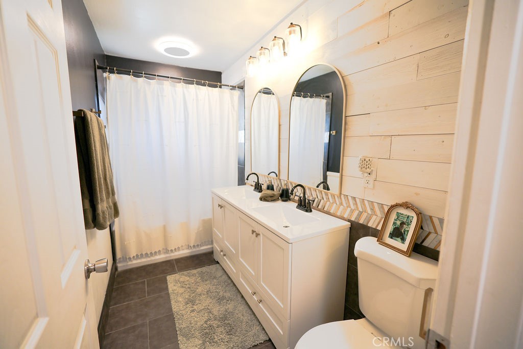 1156 3rd Street Calimesa, CA 92320 - Photo 26 of 34 a bathroom with a sink a toilet and a mirror