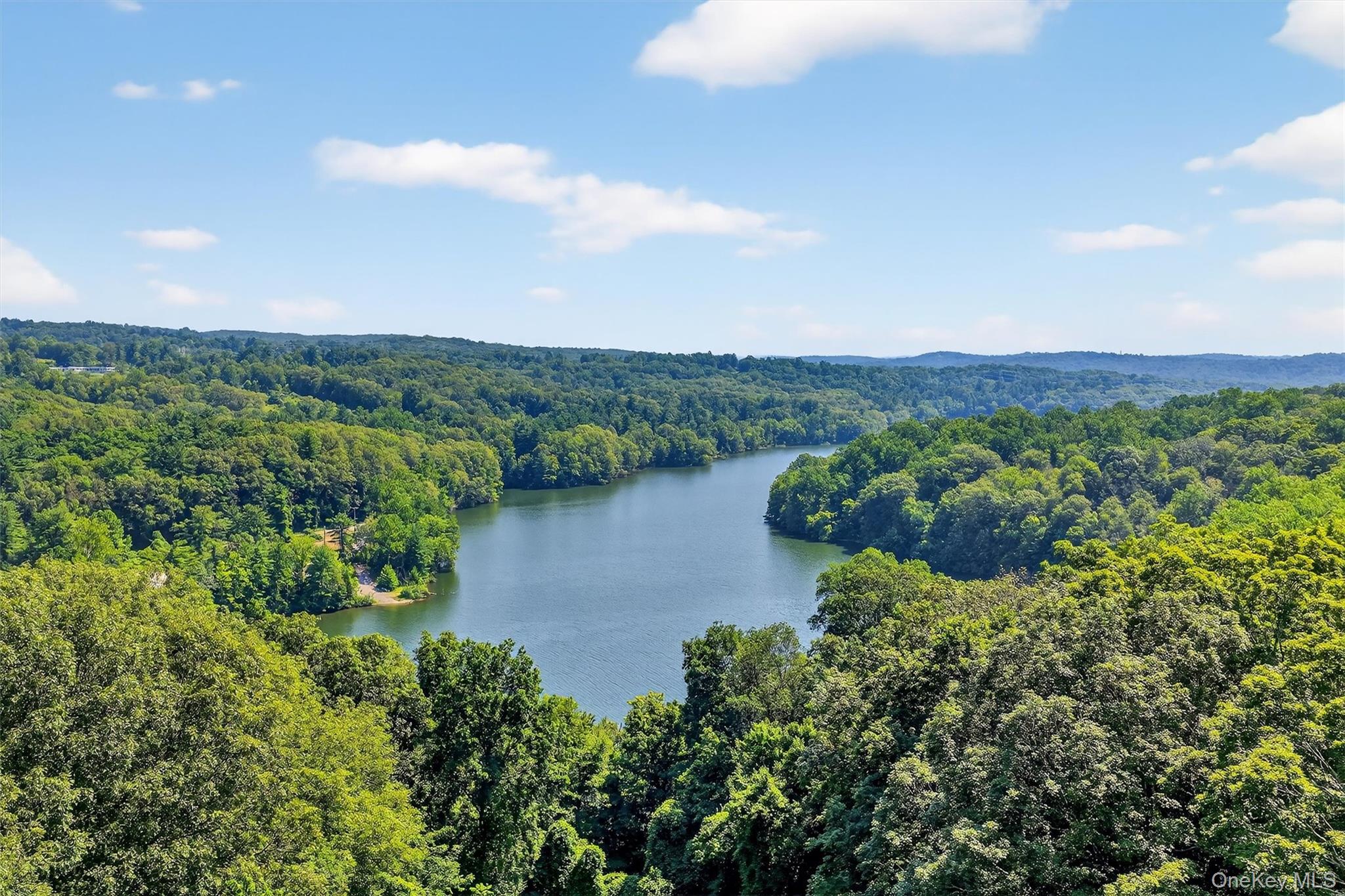 433 Arcady Road Ossining, NY 10562 - Photo 2 of 21 a view of a lake with a mountain in the background