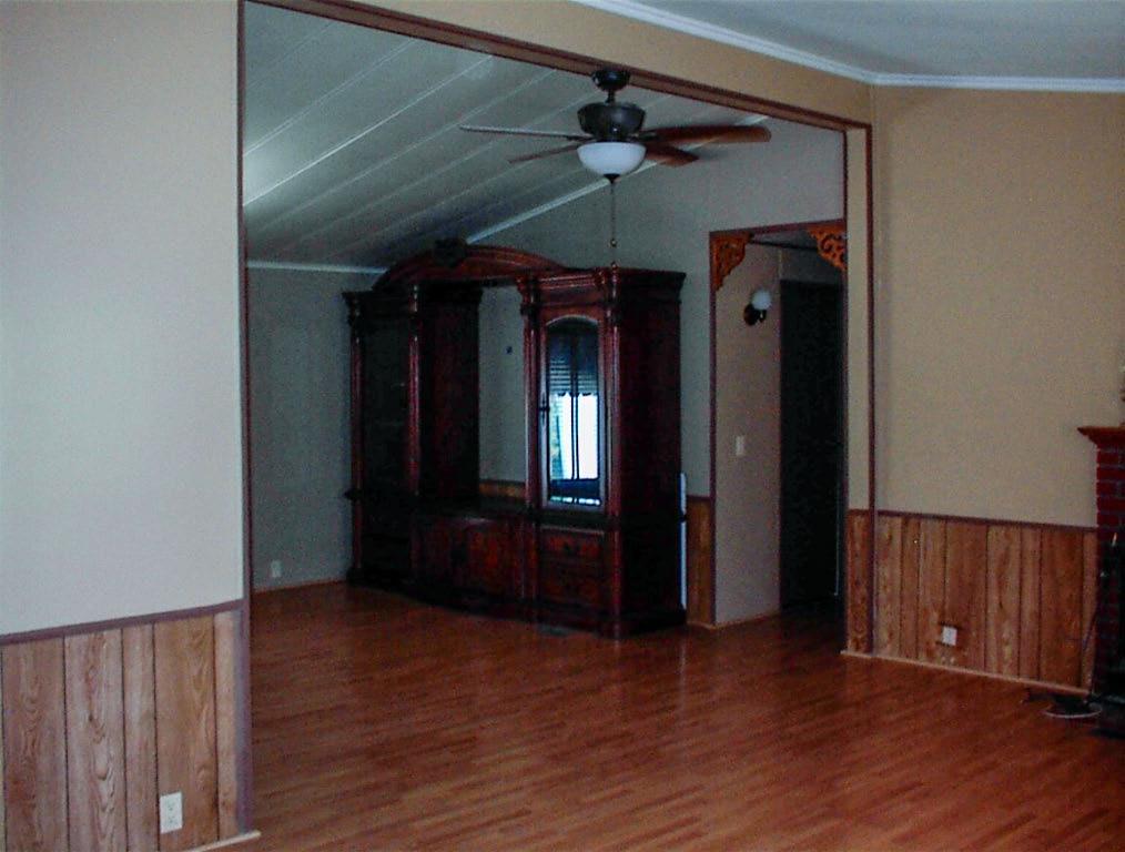 37314 Mistletoe Road Squaw Valley, CA 93675 - Photo 11 of 27 an empty room with wooden floor chandelier fan and windows
