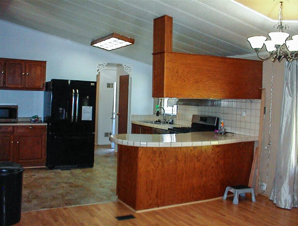37314 Mistletoe Road Squaw Valley, CA 93675 - Photo 12 of 27 a kitchen with stainless steel appliances granite countertop a refrigerator a stove and a sink