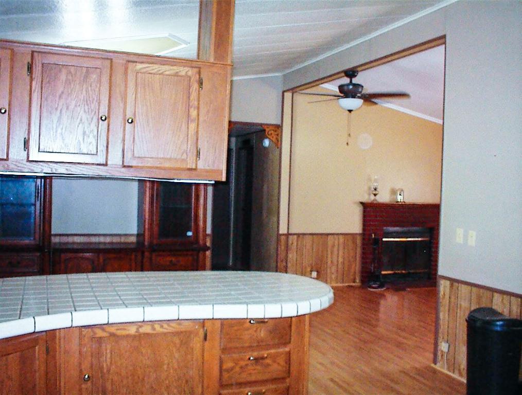 37314 Mistletoe Road Squaw Valley, CA 93675 - Photo 14 of 27 a kitchen with kitchen island a counter top space wooden floor and a cabinet