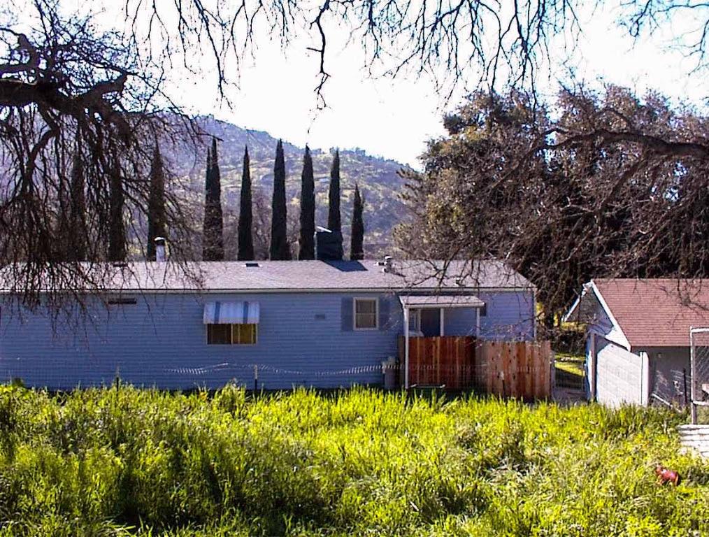 37314 Mistletoe Road Squaw Valley, CA 93675 - Photo 9 of 27 a view of a house with wooden fence