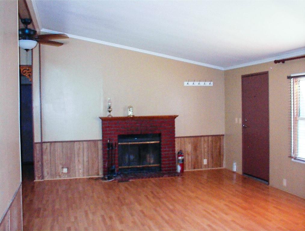 37314 Mistletoe Road Squaw Valley, CA 93675 - Photo 10 of 27 a view of an empty room with wooden floor fireplace and a window