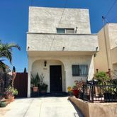 a view of a house with potted plants