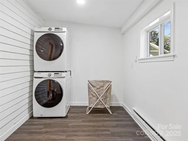 a view of a storage and utility room with wooden floor