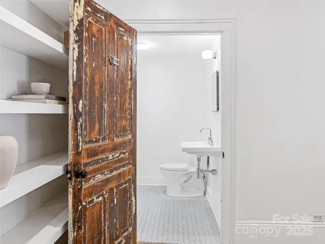 a bathroom with a shower a toilet and a sink