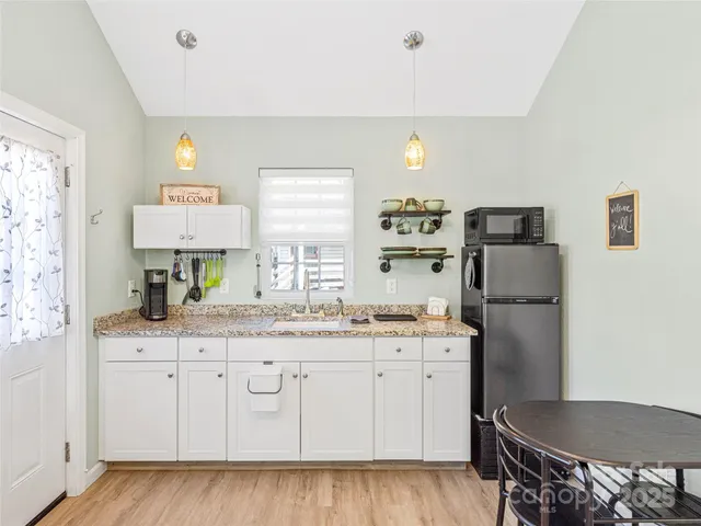 a kitchen with a stove a sink and a refrigerator