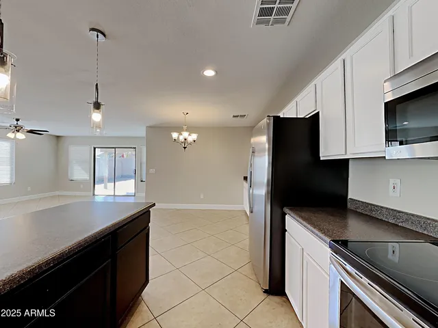 a kitchen with stainless steel appliances granite countertop a sink and a stove
