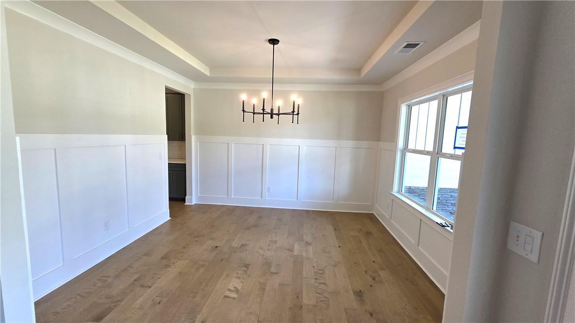 243 Holly Br Road Piedmont, SC 29673 - Photo 6 of 21 A tray ceiling and board and batten walls create a refined dining space.