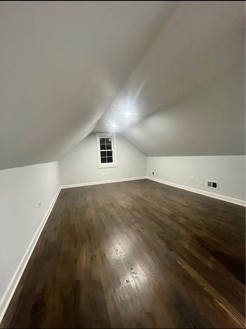 5212 South Lorel Avenue Chicago, IL 60638 - Photo 13 of 17 an empty room with wooden floor and windows
