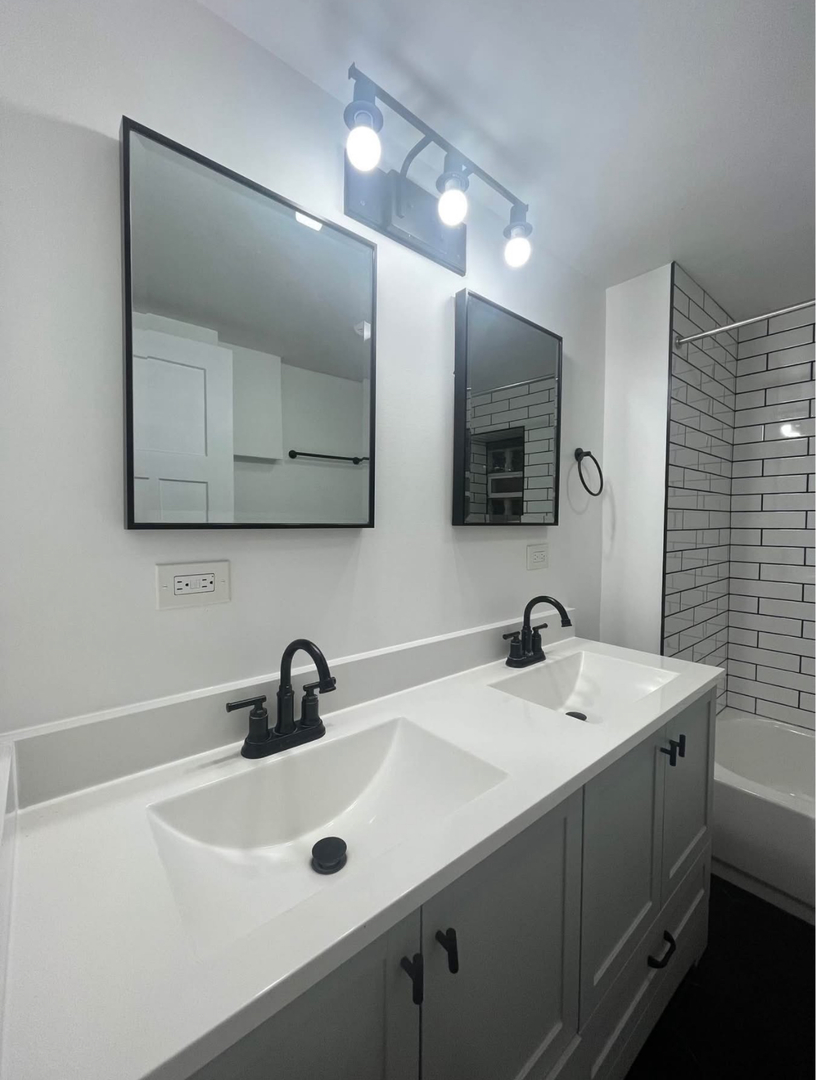 5212 South Lorel Avenue Chicago, IL 60638 - Photo 16 of 17 a bathroom with a sink and a mirror