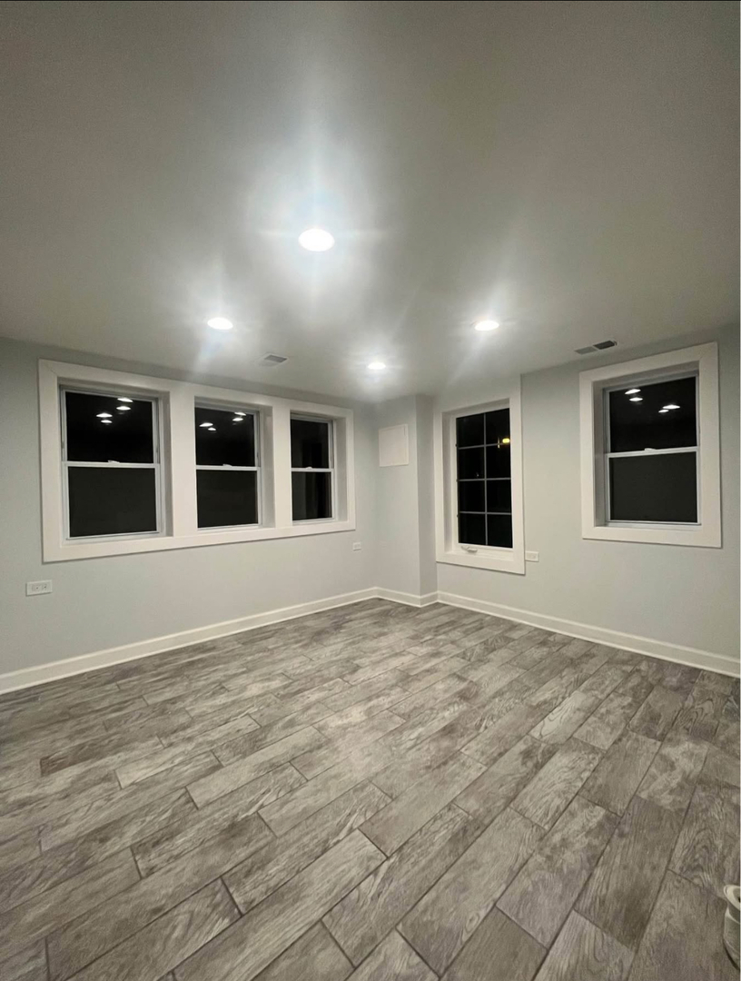 5212 South Lorel Avenue Chicago, IL 60638 - Photo 17 of 17 a view of an empty room with window and wooden floor