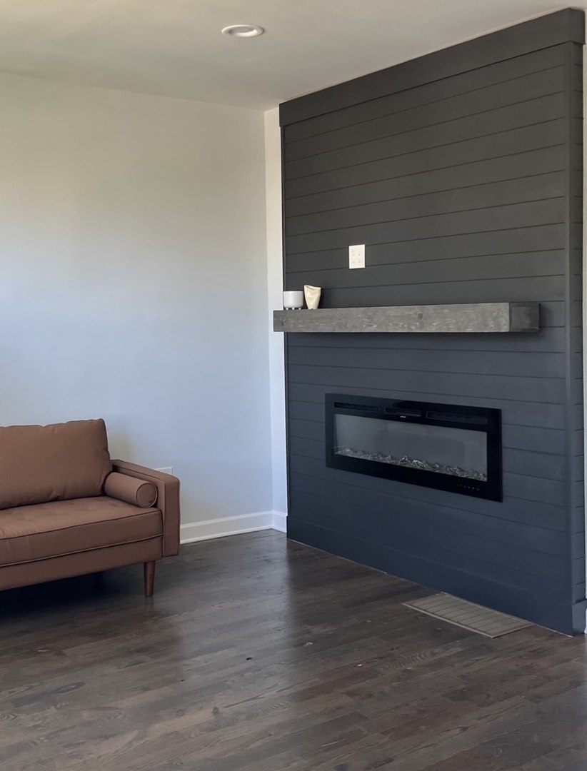 5212 South Lorel Avenue Chicago, IL 60638 - Photo 3 of 17 a living room with furniture and a fireplace