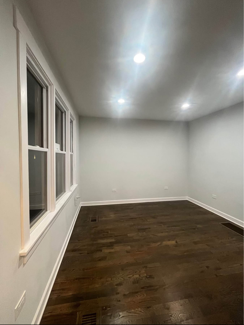 5212 South Lorel Avenue Chicago, IL 60638 - Photo 4 of 17 a view of an empty room with wooden floor and a window