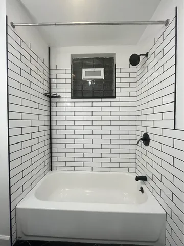 a bathroom with a bathtub and a shower